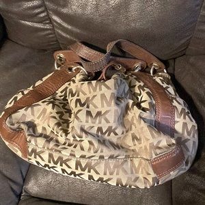 Michael Kors branded purse. Brown. Used but with plenty of life left.